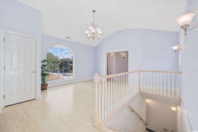 4552 River Rd, Little River, SC 29566 - stairway with wood finished floors, vaulted ceiling, and a chandelier