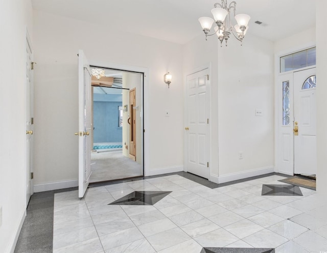 4552 River Rd, Little River, SC 29566 - foyer with a chandelier and light tile patterned floors