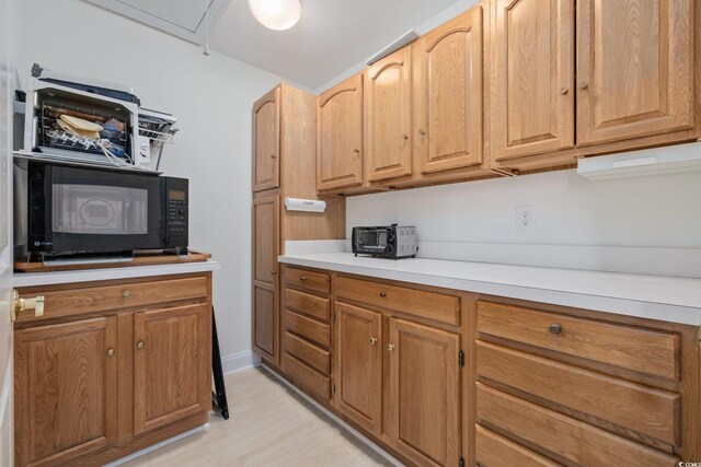 4552 River Rd, Little River, SC 29566 - kitchen with black microwave, light countertops, and light wood-style flooring