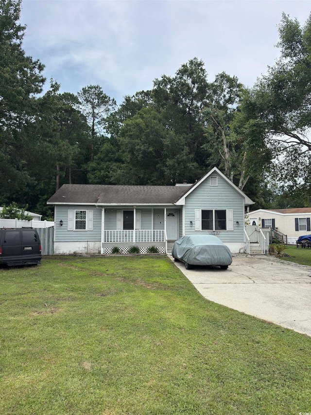 3534 Gordon Dr, Myrtle Beach, SC 29579 - view of front of house with covered porch, a front lawn, and roof with shingles