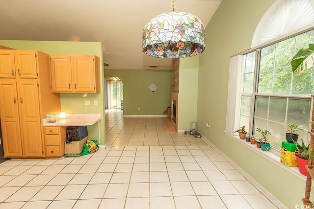 318 Muirfield Rd, Myrtle Beach, SC 29588 - kitchen featuring light countertops, light tile patterned flooring, light brown cabinetry, and lofted ceiling