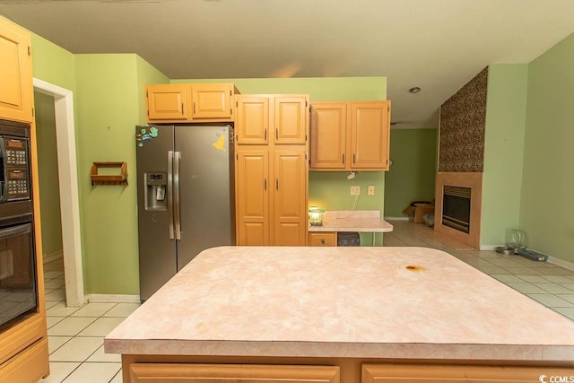 318 Muirfield Rd, Myrtle Beach, SC 29588 - kitchen with stainless steel refrigerator with ice dispenser, black oven, light tile patterned floors, and light countertops