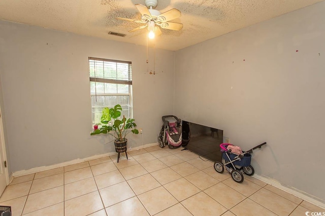 318 Muirfield Rd, Myrtle Beach, SC 29588 - unfurnished room with a textured ceiling, a ceiling fan, and light tile patterned flooring