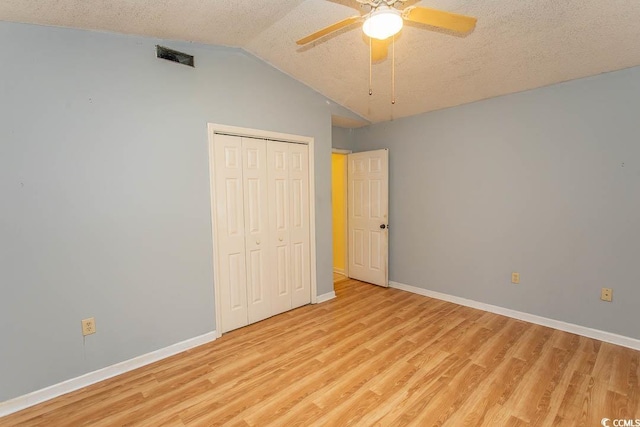 318 Muirfield Rd, Myrtle Beach, SC 29588 - unfurnished bedroom with light wood-style floors, a closet, lofted ceiling, a textured ceiling, and ceiling fan