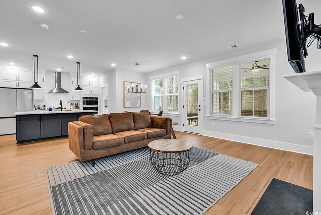 1216 Newell Dr, Myrtle Beach, SC 29588 - living room featuring light wood-style floors, a chandelier, and recessed lighting