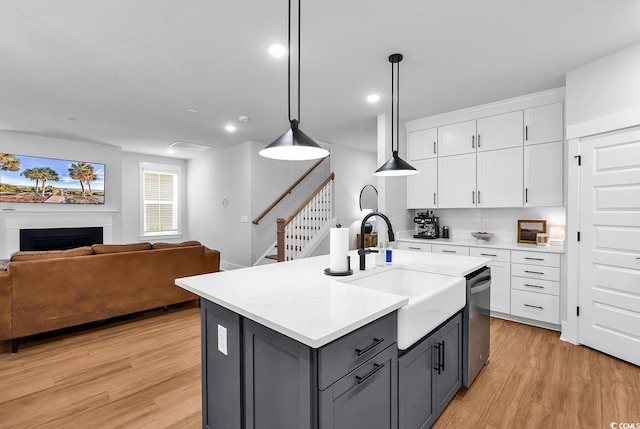 1216 Newell Dr, Myrtle Beach, SC 29588 - kitchen with gray cabinets, light wood finished floors, open floor plan, dishwasher, and white cabinets