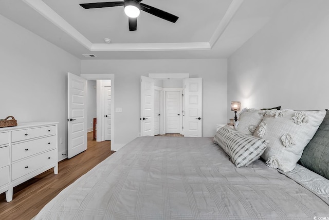 1216 Newell Dr, Myrtle Beach, SC 29588 - bedroom featuring a raised ceiling, wood finished floors, and a ceiling fan