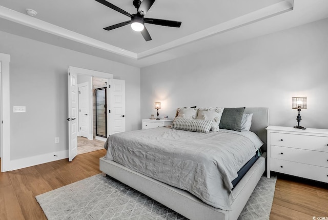 1216 Newell Dr, Myrtle Beach, SC 29588 - bedroom with a raised ceiling, wood finished floors, and ceiling fan