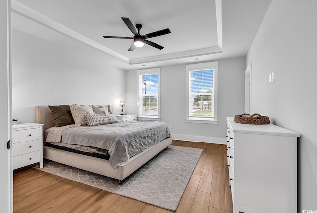 1216 Newell Dr, Myrtle Beach, SC 29588 - bedroom featuring a tray ceiling, light wood finished floors, and ceiling fan