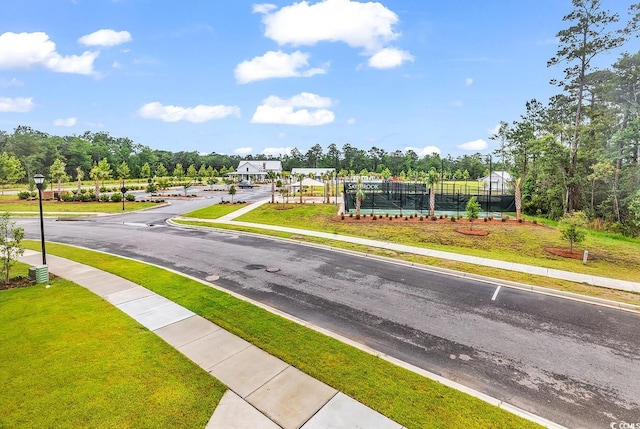 1216 Newell Dr, Myrtle Beach, SC 29588 - view of asphalt street featuring sidewalks, street lighting, view of scattered trees, and curbs