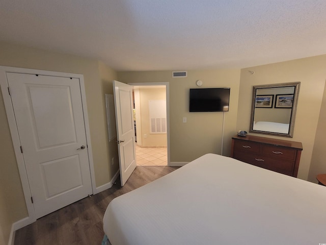 201 S Ocean Blvd Unit 205, Myrtle Beach, SC 29577 - bedroom with dark wood-style flooring and baseboards