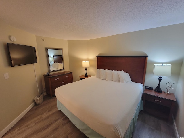 201 S Ocean Blvd Unit 205, Myrtle Beach, SC 29577 - bedroom with wood finished floors and a textured ceiling