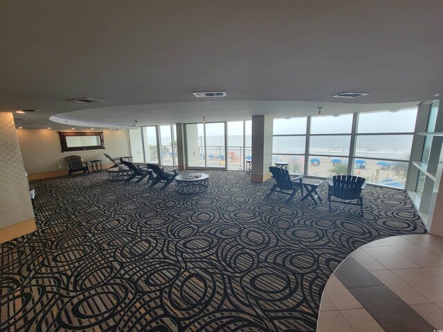 201 S Ocean Blvd Unit 205, Myrtle Beach, SC 29577 - workout area with tile patterned floors, a water view, expansive windows, and carpet