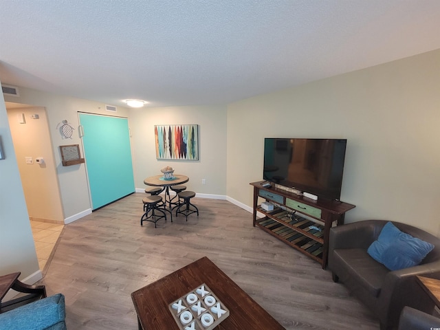 201 S Ocean Blvd Unit 205, Myrtle Beach, SC 29577 - living area with wood finished floors and a textured ceiling