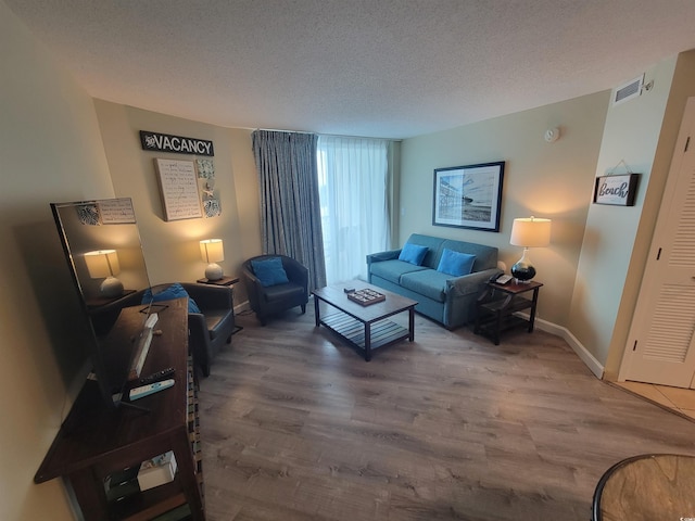 201 S Ocean Blvd Unit 205, Myrtle Beach, SC 29577 - living area featuring wood finished floors and a textured ceiling