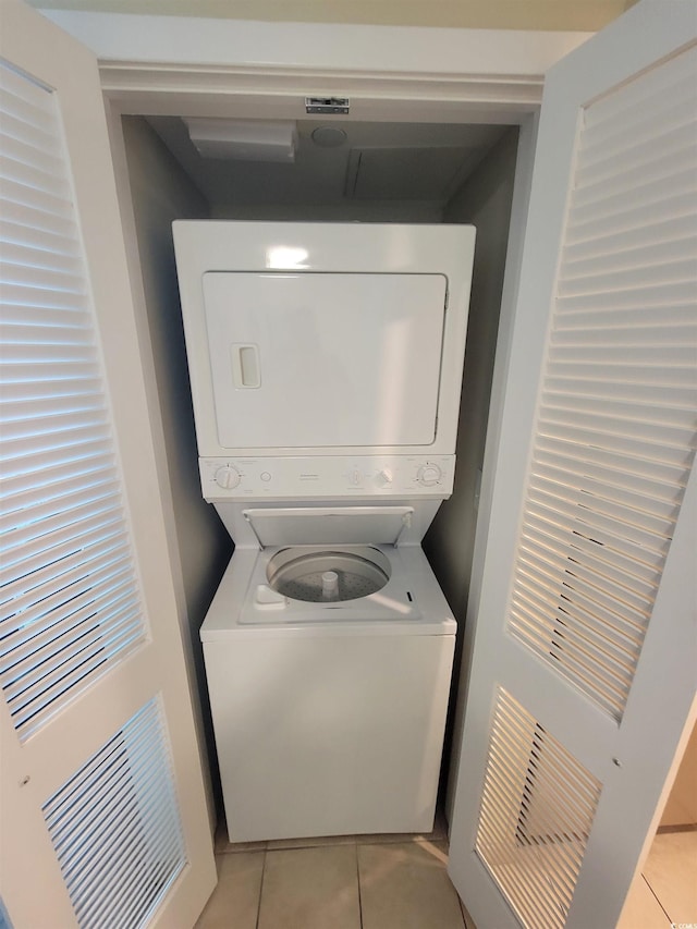 201 S Ocean Blvd Unit 205, Myrtle Beach, SC 29577 - washroom featuring stacked washer / drying machine and light tile patterned floors