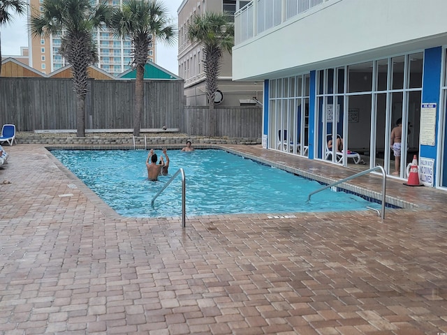 201 S Ocean Blvd Unit 205, Myrtle Beach, SC 29577 - community pool with a fenced backyard and a patio area