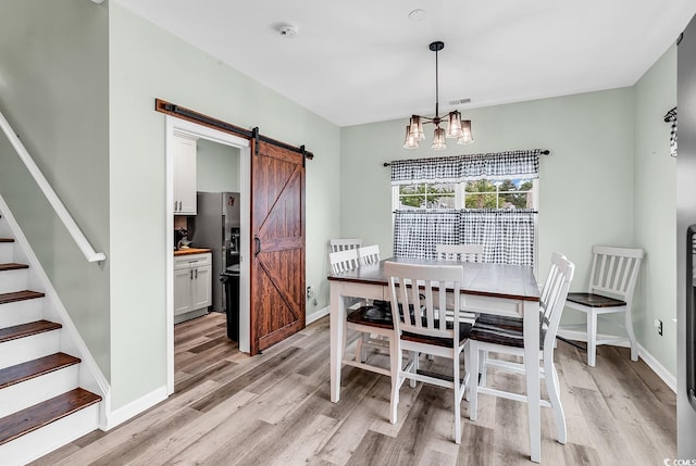 209 Haley Brooke Dr, Conway, SC 29526 - dining area with a barn door, light wood-style flooring, stairs, and a chandelier