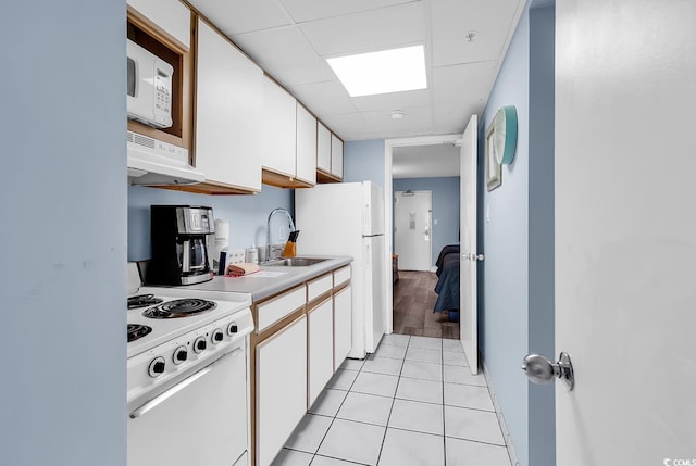 2300 N Ocean Blvd Unit 132, Myrtle Beach, SC 29577 - kitchen with white appliances, white cabinetry, light countertops, light tile patterned floors, and a drop ceiling
