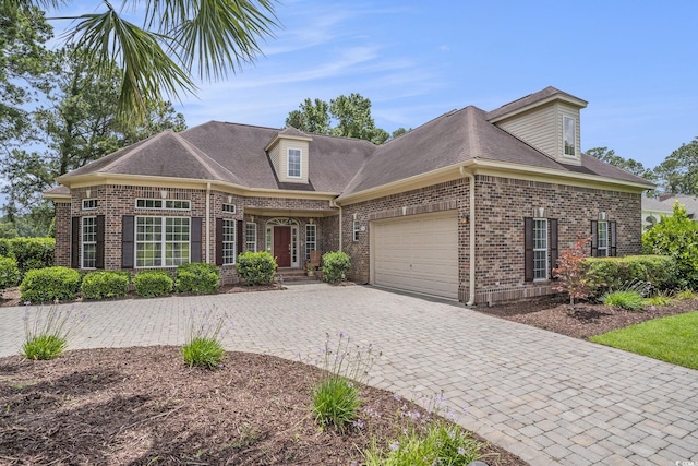 280 Oatland Lake Rd, Pawleys Island, SC 29585 - view of front of property featuring a garage, brick siding, decorative driveway, and a shingled roof