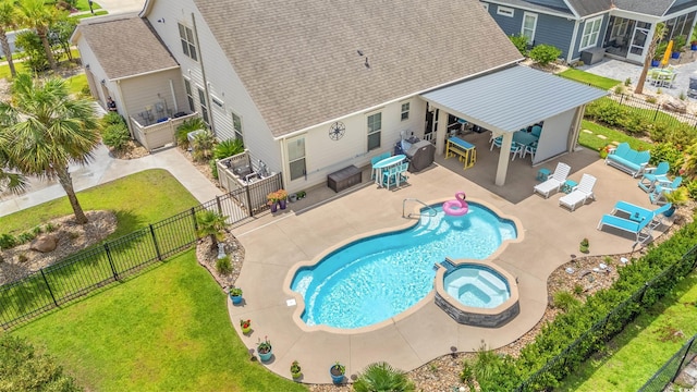 1715 Lake Egret Dr, North Myrtle Beach, SC 29582 - view of swimming pool featuring a pool with connected hot tub, a fenced backyard, a patio area, and outdoor lounge area