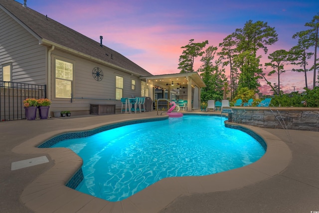 1715 Lake Egret Dr, North Myrtle Beach, SC 29582 - pool at dusk with a patio area, an outdoor pool, and a ceiling fan