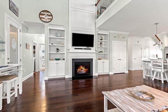1715 Lake Egret Dr, North Myrtle Beach, SC 29582 - living area featuring ornamental molding, a fireplace with flush hearth, dark wood-type flooring, and built in shelves