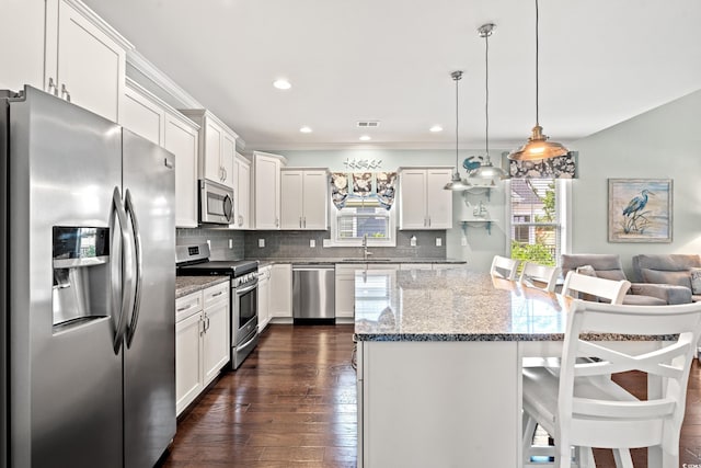 1715 Lake Egret Dr, North Myrtle Beach, SC 29582 - kitchen featuring stainless steel appliances, plenty of natural light, a center island, a breakfast bar area, and recessed lighting