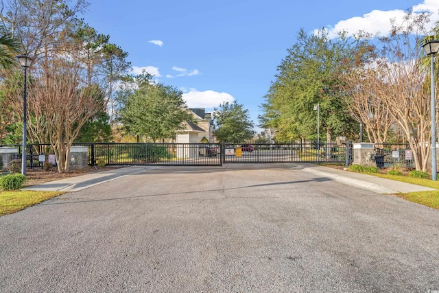 1654 Low Country Pl Unit C, Myrtle Beach, SC 29577 - view of asphalt road featuring street lighting, sidewalks, a gate, a gated entry, and curbs