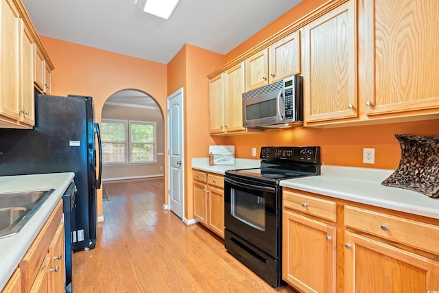 1654 Low Country Pl Unit C, Myrtle Beach, SC 29577 - kitchen featuring stainless steel microwave, black range with electric stovetop, light brown cabinetry, light wood finished floors, and arched walkways