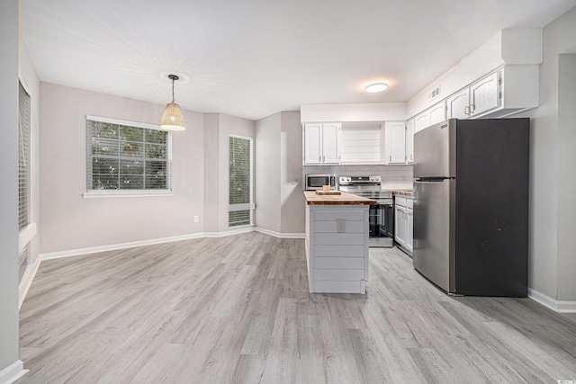 1500 Cenith Dr Unit B-403, North Myrtle Beach, SC 29582 - kitchen with stainless steel appliances, wood counters, light wood-style floors, decorative light fixtures, and white cabinets