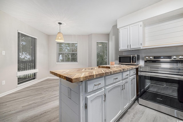 1500 Cenith Dr Unit B-403, North Myrtle Beach, SC 29582 - kitchen with appliances with stainless steel finishes, butcher block countertops, light wood finished floors, and hanging light fixtures