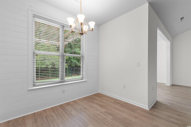 124 Shady Arbor Loop, Longs, SC 29568 - unfurnished dining area with light wood-style flooring, a chandelier, and wood walls