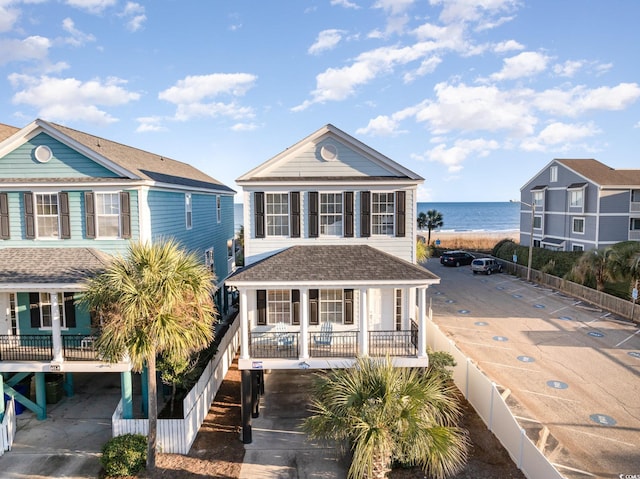 611 N Ocean Blvd, Surfside Beach, SC 29575 - beach home featuring a water view, a porch, a carport, and roof with shingles