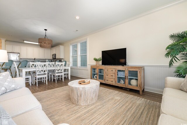 611 N Ocean Blvd, Surfside Beach, SC 29575 - living room with wood finished floors, crown molding, and wainscoting