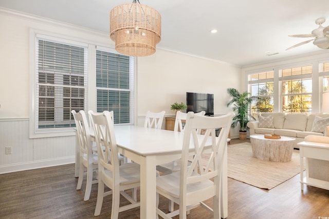 611 N Ocean Blvd, Surfside Beach, SC 29575 - dining space with wood finished floors, ornamental molding, a chandelier, a wainscoted wall, and a ceiling fan