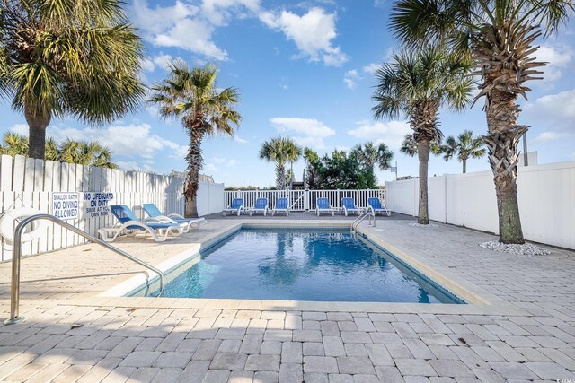 611 N Ocean Blvd, Surfside Beach, SC 29575 - community pool featuring a patio area and a fenced backyard