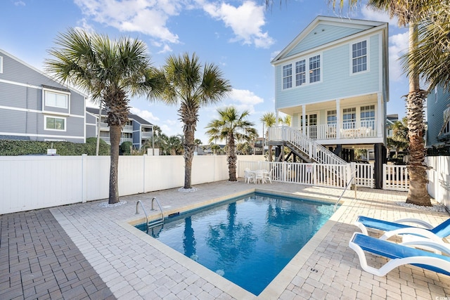 611 N Ocean Blvd, Surfside Beach, SC 29575 - view of swimming pool featuring stairs, a fenced backyard, and a patio area