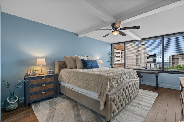 7601 N Ocean Blvd Unit 7-C, Myrtle Beach, SC 29572 - bedroom featuring dark wood-style floors, beamed ceiling, and a ceiling fan