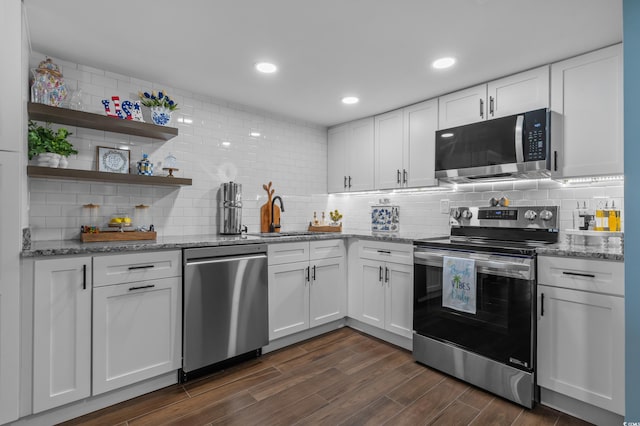 7601 N Ocean Blvd Unit 7-C, Myrtle Beach, SC 29572 - kitchen with stainless steel appliances, light stone countertops, backsplash, white cabinetry, and recessed lighting