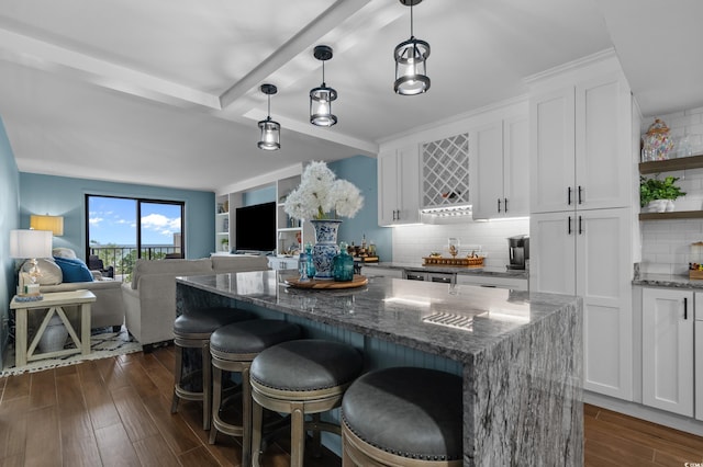 7601 N Ocean Blvd Unit 7-C, Myrtle Beach, SC 29572 - kitchen featuring white cabinets, dark wood-type flooring, beam ceiling, decorative backsplash, and dark stone counters