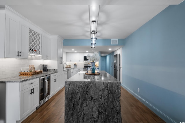 7601 N Ocean Blvd Unit 7-C, Myrtle Beach, SC 29572 - kitchen with beverage cooler, dark wood-type flooring, a center island, backsplash, and light stone counters