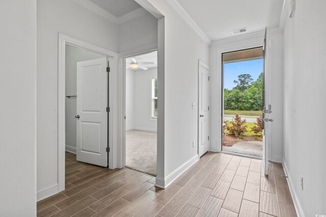 124 Castaway Key Dr, Pawleys Island, SC 29585 - entryway featuring wood tiled floors, healthy amount of natural light, ornamental molding, and ceiling fan