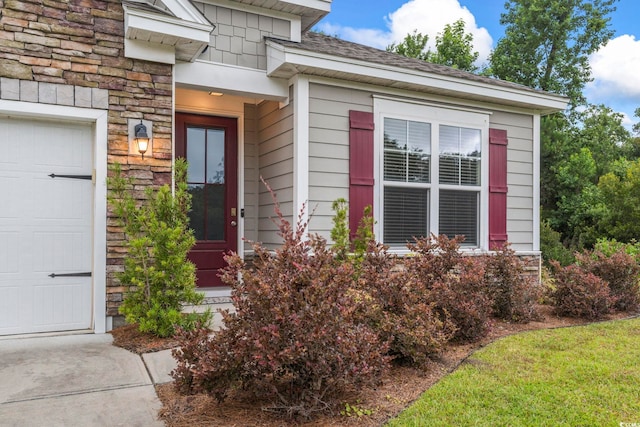 124 Castaway Key Dr, Pawleys Island, SC 29585 - view of exterior entry featuring stone siding and an attached garage