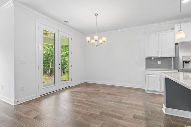 124 Castaway Key Dr, Pawleys Island, SC 29585 - kitchen with stainless steel fridge, ornamental molding, a chandelier, white cabinets, and tasteful backsplash