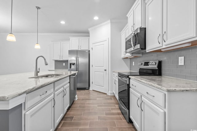 124 Castaway Key Dr, Pawleys Island, SC 29585 - kitchen with stainless steel appliances, ornamental molding, backsplash, white cabinets, and recessed lighting