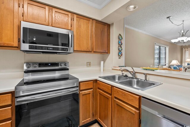 305 Hillside Dr N Unit 205, North Myrtle Beach, SC 29582 - kitchen with appliances with stainless steel finishes, crown molding, light countertops, a chandelier, and a textured ceiling