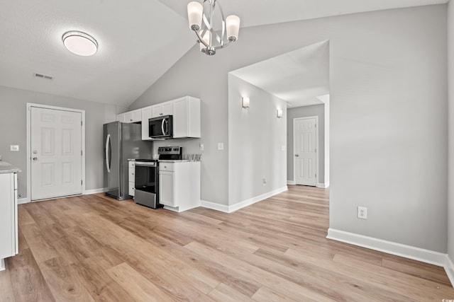 2965 Mount Olive Rd, Loris, SC 29569 - kitchen featuring stainless steel appliances, white cabinetry, lofted ceiling, light wood-type flooring, and a chandelier