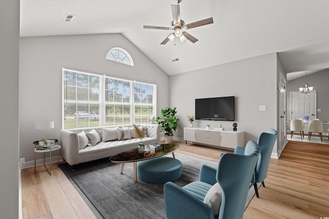 2965 Mount Olive Rd, Loris, SC 29569 - living room featuring light wood-style flooring, a chandelier, a ceiling fan, and high vaulted ceiling