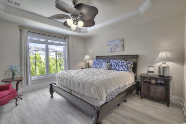 2180 Waterview Dr Unit 738, North Myrtle Beach, SC 29582 - bedroom featuring a tray ceiling, wood finished floors, ornamental molding, and a ceiling fan